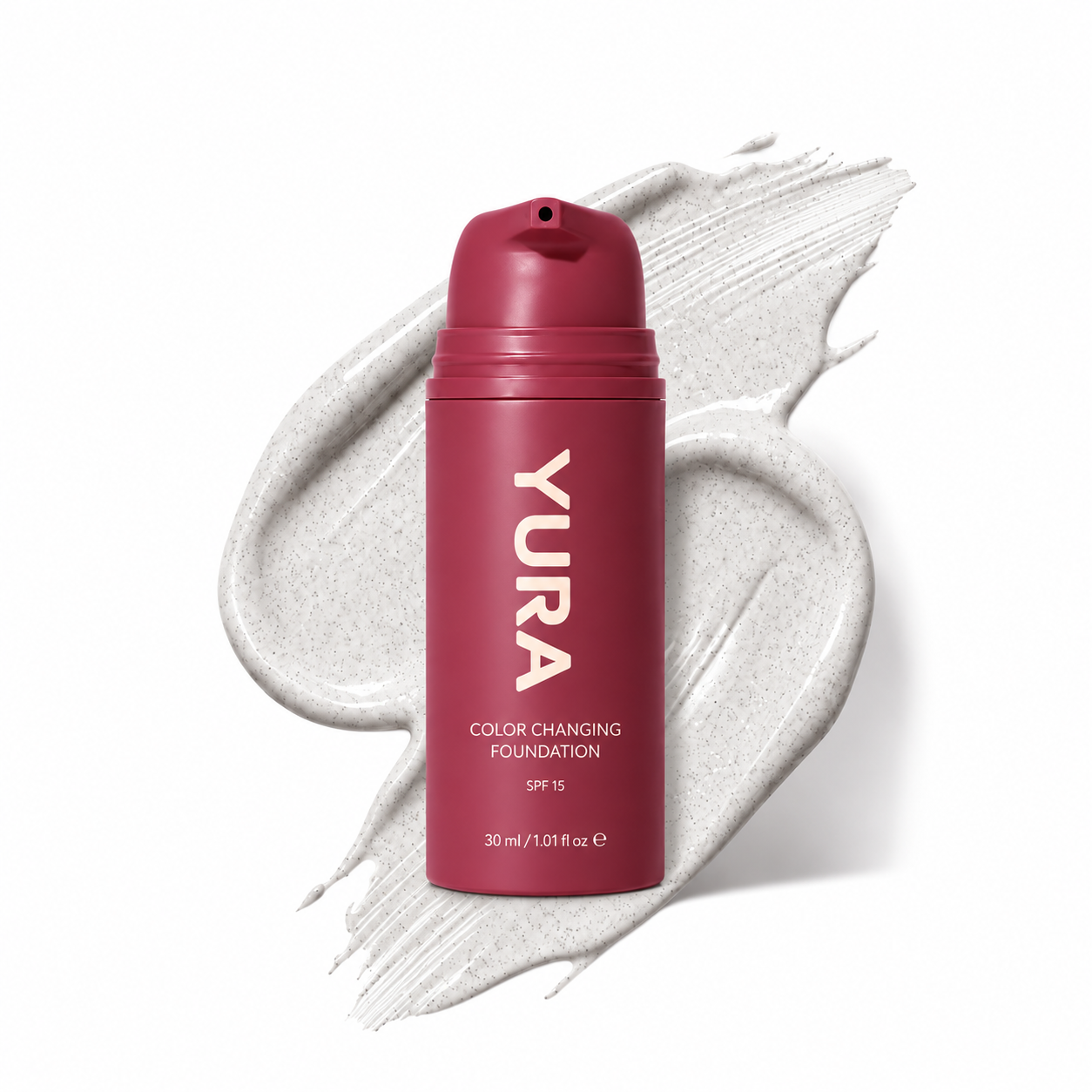 Burgundy YURA adaptive foundation bottle on a white foundation texture